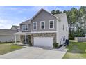 Well-kept two-story home boasting a stone facade, covered porch, and spacious driveway at 118 Beacon Falls Ct, Summerville, SC 29486