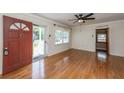 Bright living room features hardwood floors, fan, and a large window at 1226 Forestwood Dr, Charleston, SC 29407