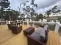 Relaxing outdoor space with wicker furniture, offering serene views of the surrounding landscape and the water at 123 Jungle Rd, Edisto Island, SC 29438
