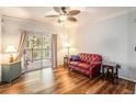 Living room showing hard surface floors, ceiling fan, sliding glass door, and furniture at 1300 Park West Blvd # 811, Mount Pleasant, SC 29466