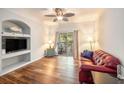 Living room boasts hard surface floors, ceiling fan, sliding glass door, and built in shelving at 1300 Park West Blvd # 811, Mount Pleasant, SC 29466