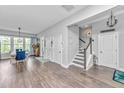 Bright entryway featuring hardwood floors, a staircase, and a dining area at 133 Alder Cir, Charleston, SC 29412