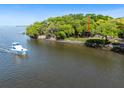 Waterfront home on a beautiful point lot with surrounding trees, offering privacy and scenic views at 1405 S Edgewater Dr, Charleston, SC 29407