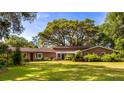 Charming single story home with manicured lawn and mature trees providing a serene outdoor space at 1405 S Edgewater Dr, Charleston, SC 29407