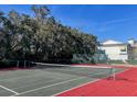 Well-maintained community tennis court surrounded by greenery and fencing at 1481 Center Street # 302, Mount Pleasant, SC 29464