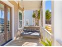 Relaxing front porch swing and view of neighborhood landscaping at 1580 Cranes Nest Rd, Mount Pleasant, SC 29466