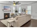 Cozy living room with a fireplace, hardwood floors, and a comfy sectional sofa at 1753 Bee Balm Rd, Johns Island, SC 29455