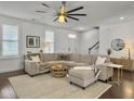Bright living room features hardwood floors, white walls, and a large comfy sectional sofa at 1753 Bee Balm Rd, Johns Island, SC 29455