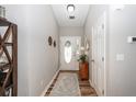 Inviting foyer with hardwood floors, neutral paint, decorative accents, and a front door with an oval window at 1922 Cedar Petal Ln, Charleston, SC 29414