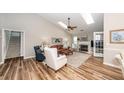 Bright living room features a fireplace, skylights, hardwood floors, neutral paint, and comfortable furnishings at 1922 Cedar Petal Ln, Charleston, SC 29414
