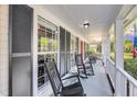 Inviting front porch with classic rocking chairs, perfect for enjoying the outdoors and neighborhood views at 1938 Oak Tree Ln, Mount Pleasant, SC 29464