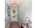 Bright hallway featuring hardwood floors, light blue walls, and a beautiful Tiffany-style hanging light at 1992 Kings Gate Ln, Mount Pleasant, SC 29466