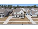 Spacious suburban home with a well-manicured lawn, surrounded by lush greenery and neighboring houses at 2064 Parish House Cir, Johns Island, SC 29455