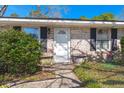 Inviting front entrance with brick facade, decorative shutters, and charming potted plants at 2138 Clayton St, Charleston, SC 29414