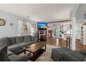 Open-concept living room with stylish decor, a gray sectional, and seamless flow to the kitchen at 2138 Clayton St, Charleston, SC 29414