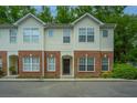Charming two-story townhouse with brick and siding, nestled in a tree-lined neighborhood at 241 Howle Ave # H, Charleston, SC 29412
