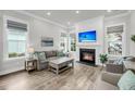 Cozy living room with a fireplace, large windows, and comfortable seating at 2729 Battery Pringle Dr, Johns Island, SC 29455