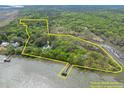 Waterfront estate on lush, wooded acreage, featuring a private dock at 2970 Roseville Rd, Wadmalaw Island, SC 29487
