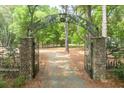 Stone pillars, ornamental gates and a brick drive welcome you to this grand property at 2970 Roseville Rd, Wadmalaw Island, SC 29487