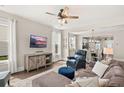 Comfortable living room features a ceiling fan, a plush couch, and an entertainment center at 308 Watergrass St, Summerville, SC 29486