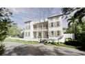 Two-story home with a charming balcony and shutters, nestled among lush trees on a beautiful day at 33 Duany Rd, Mount Pleasant, SC 29464