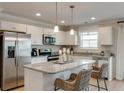 Stylish kitchen boasts white cabinetry, stainless steel appliances, and a granite island at 333 O'Leary Circle, Summerville, SC 29483