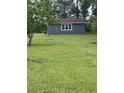Well-maintained, matching shed with window and ample space for storage or hobbies at 341 Sugar Hill Rd, Saint George, SC 29477