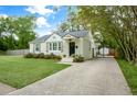 Inviting one-story home features a concrete driveway leading to a gated entrance and a well-maintained front lawn at 35 Campbell Dr, Charleston, SC 29407