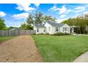 Quaint single-story home with a gravel driveway, lush green lawn, and a charming, white-painted exterior at 35 Campbell Dr, Charleston, SC 29407