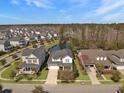 Overhead view of a lovely neighborhood with houses surrounding a scenic pond and green spaces at 3608 Maidstone Dr, Mount Pleasant, SC 29466