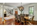 Elegant dining room showcasing hardwood floors, sophisticated lighting, and easy access to the entry at 3924 Regal Oak Ln, Johns Island, SC 29455