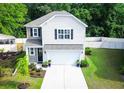 Charming two-story home featuring a manicured lawn, a two car garage, and tasteful landscaping at 3952 Treebranch Cir Cir, Mount Pleasant, SC 29429