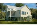 Rear exterior view of a charming two-story home featuring a screened porch and well-maintained lawn at 3997 Chantey Crest, Johns Island, SC 29455