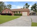 Beautiful brick house boasting an attached garage, mature trees, and a long driveway at 415 Whitebark Dr, Ladson, SC 29456