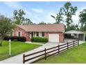 Lovely single story home featuring a carport, attached garage, and a partially fenced yard at 415 Whitebark Dr, Ladson, SC 29456