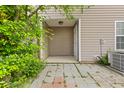 Cozy back porch area with stone pavers and verdant foliage providing privacy and shade at 4209 Climbing Tree Ct, Charleston, SC 29414