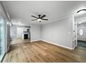 Open-concept living space with hardwood floors connecting living and kitchen areas with natural light at 4343 Helene Dr, North Charleston, SC 29418