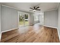 Spacious living room with hardwood floors, ceiling fan, and sliding glass door to the backyard at 4343 Helene Dr, North Charleston, SC 29418