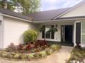 Inviting entrance with manicured flowerbeds and hanging ferns, creating a warm welcome at 4414 Rice Mill Dr, North Charleston, SC 29420