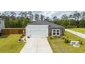 Aerial view of a single-story home featuring a landscaped yard, two-car garage, and a driveway at 477 Spanish Wells Rd, Summerville, SC 29486