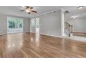 Spacious living room with wood floors, stairs to the upper level, and sliding glass doors to the backyard at 543 Castle Hall Rd, Mount Pleasant, SC 29464