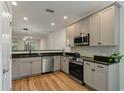 Modern kitchen featuring gray cabinetry, stainless steel appliances and granite countertops at 5514 Colonial Chatsworth Cir, North Charleston, SC 29418