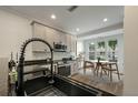 Modern kitchen featuring sleek countertops, stainless steel appliances, and an eat-in dining area at 5514 Colonial Chatsworth Cir, North Charleston, SC 29418
