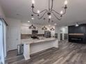 Open kitchen featuring a large island, modern appliances, and decorative lighting at 619 Hilchot Dr, Summerville, SC 29486