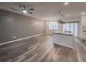 Open-concept living room with modern lighting, ceiling fan, and wood-look floors at 619 Hilchot Dr, Summerville, SC 29486