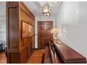 Charming entryway features wooden paneling, a piano, and a decorative pendant light fixture at 6305 Brandt St, North Charleston, SC 29406