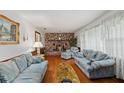 Spacious living room with hardwood floors, a brick fireplace, and comfortable blue sofas at 6305 Brandt St, North Charleston, SC 29406