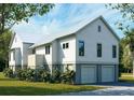 Rear exterior of home, featuring white siding, a metal roof, and a convenient two-car garage at 7059 Sounding Ln, Johns Island, SC 29455