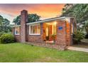 Close up of the red brick, one story home with front door at 757 Longfellow Rd, Charleston, SC 29407