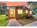 A charming brick home featuring a cozy front porch and updated lighting at 757 Longfellow Rd, Charleston, SC 29407